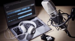 Podcast microphone, headphones, and computer editing