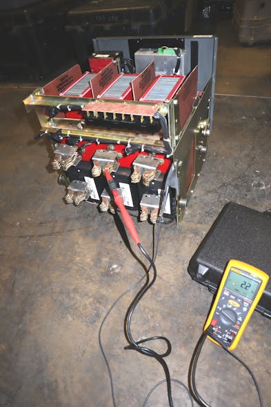 Photo 1a. The megohmmeter has given way to more sophisticated test equipment such as this insulation resistance tester being used for insulation resistance testing of a low-voltage power circuit breaker.