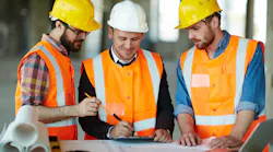 construction workers reviewing plans