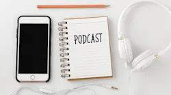podcast written on notebook with phone and headphones