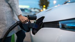 woman charging electric vehicle