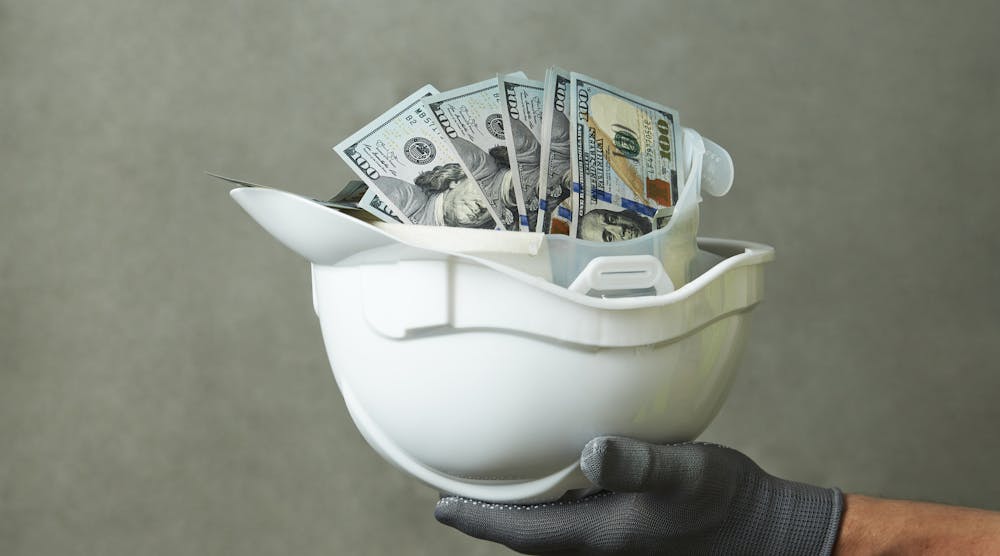 construction helmet filled with american money
