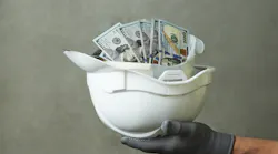 construction helmet filled with cash