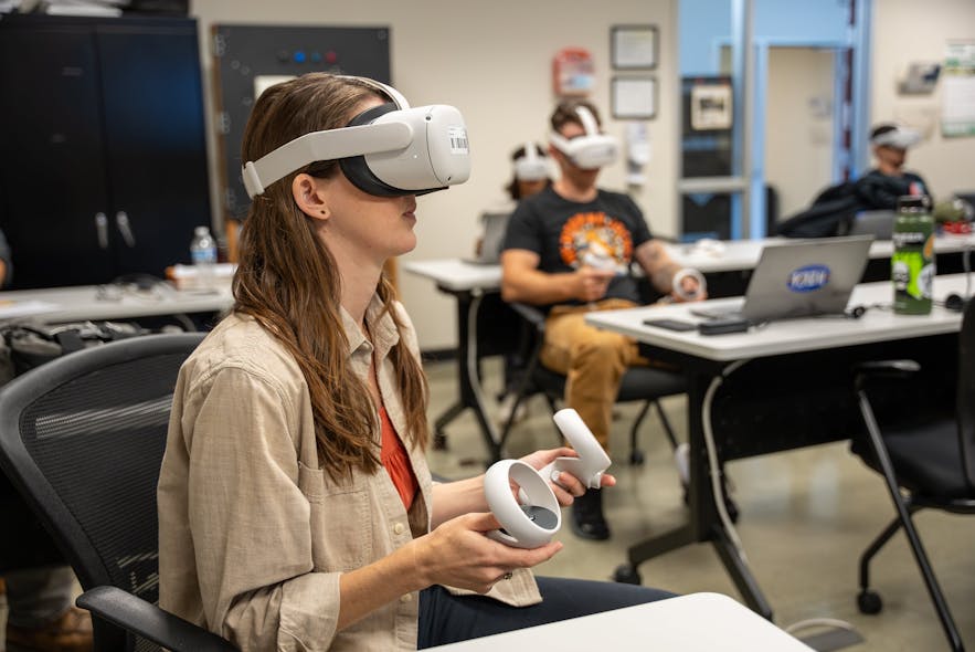 A WECA apprentice explores BESS using a VR headset.