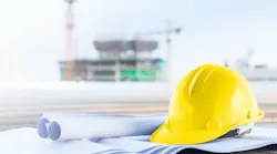 construction helmet with plans on site