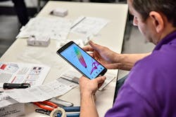 Photo 4. Maintenance accesses a phone app to change settings. Photo 4. Maintenance accesses a phone app to change settings.