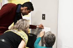 Photo 1. Users gang up on a malfunctioning wall control. Photo 1. Users gang up on a malfunctioning wall control.