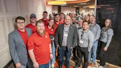 The winning team from Ferris State University celebrates their first place award alongside the judging panel. The winning team from Ferris State University celebrates their first place award alongside the judging panel.