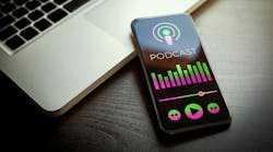 podcast on phone with laptop
