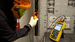 Photo 2. This worker is attaching the current clamp from a power quality analyzer to a feeder conductor supplying a three-phase panelboard in a data facility. Study power quality to track down some of those “mysterious” equipment problems. Photo 2. This worker is attaching the current clamp from a power quality analyzer to a feeder conductor supplying a three-phase panelboard in a data facility. Study power quality to track down some of those “mysterious” equipment problems.