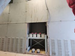 Photo 1. This battery system was hidden behind a metal panel cover. Photo 1. This battery system was hidden behind a metal panel cover.