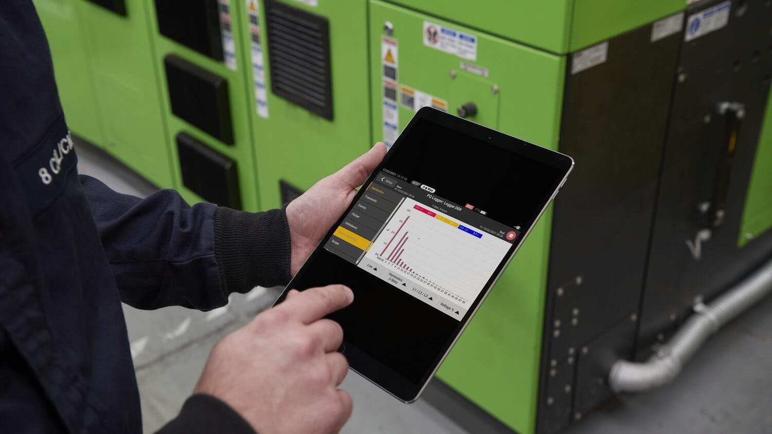 Electrician analyzing data on tablet