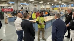 Photo 2. Antrell Robinson, a first-year apprentice and graduate of Transit Tech HS, explains to Brooklyn D.A. Eric Gonzalez how to deliver power through switches to receptacles using BX cable. Photo 2. Antrell Robinson, a first-year apprentice and graduate of Transit Tech HS, explains to Brooklyn D.A. Eric Gonzalez how to deliver power through switches to receptacles using BX cable.