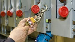 Close up shot of someone's hands locking out an electrical box Close up shot of someone's hands locking out an electrical box