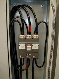 Photo 2. Jumpers installed to the line and load side of a breaker create a safety hazard. Photo 2. Jumpers installed to the line and load side of a breaker create a safety hazard.