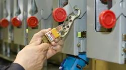 A close up of an electrical working locking out / tagging out a piece of electrical equipment