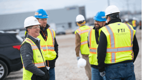Pictured left, Mike Jansen, CEO of Faith Technologies Incorporated (FTI), talking with FTI team members on a job site.