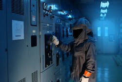 An electrical worker wearing an arc flash suit working on electrical equipment An electrical worker wearing an arc flash suit working on electrical equipment