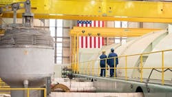 Inspectors walk the area around turbines at the Crane Energy Center. Inspectors walk the area around turbines at the Crane Energy Center.