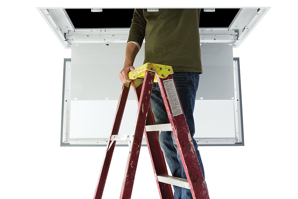 Photo 3. Forward-thinking lighting manufacturers have designed and engineered plenum-access luminaires that allow access to the equipment in the ceiling by providing a panel or opening within the unit itself. This engineering simplifies ceiling layout, prevents the disruption caused by removing a luminaire, and permits a quick return to full function.