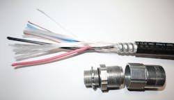 Photo 4. Type metal clad – hazardous location (MC-HL) cable is a common wiring method found in hazardous (classified) locations in addition to rigid conduit. The listed cable has a gas and vapor-tight continuous corrugated metallic sheath with a PVC jacket. The separate equipment grounding conductor (bare copper in the image) is also required. The cable connector at the bottom of the image is identified for MC-HL cable use in hazardous (classified) locations. Photo 4. Type metal clad – hazardous location (MC-HL) cable is a common wiring method found in hazardous (classified) locations in addition to rigid conduit. The listed cable has a gas and vapor-tight continuous corrugated metallic sheath with a PVC jacket. The separate equipment grounding conductor (bare copper in the image) is also required. The cable connector at the bottom of the image is identified for MC-HL cable use in hazardous (classified) locations.