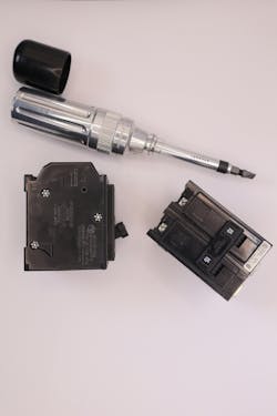 Photo 2. Sec. 110.14 provides torque requirements for terminal connections. One method is the use of the torque screwdriver. The torque requirements are provided on the molded-case breaker. The screwdriver is adjusted by first removing the cap from the end of the tool. Photo 2. Sec. 110.14 provides torque requirements for terminal connections. One method is the use of the torque screwdriver. The torque requirements are provided on the molded-case breaker. The screwdriver is adjusted by first removing the cap from the end of the tool.