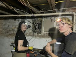 Two apprentices work to install dedicated circuits for appliances. Two apprentices work to install dedicated circuits for appliances.