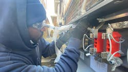 An apprentice installs a 200A service entrance cable to a meter socket. An apprentice installs a 200A service entrance cable to a meter socket.
