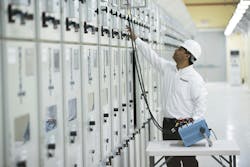 Photo 1. A test engineer verifies information on the relay under test. Photo 1. A test engineer verifies information on the relay under test.