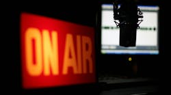 Microphone Interview. Radio studio with focus on the microphone and the interview about to unfold. Images features illuminated On Air sign and wave form monitor. Microphone Interview. Radio studio with focus on the microphone and the interview about to unfold. Images features illuminated On Air sign and wave form monitor.