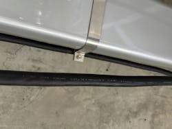 Photo 2. EVSE Level 2 charger output cable in parking garage. Photo 2. EVSE Level 2 charger output cable in parking garage.