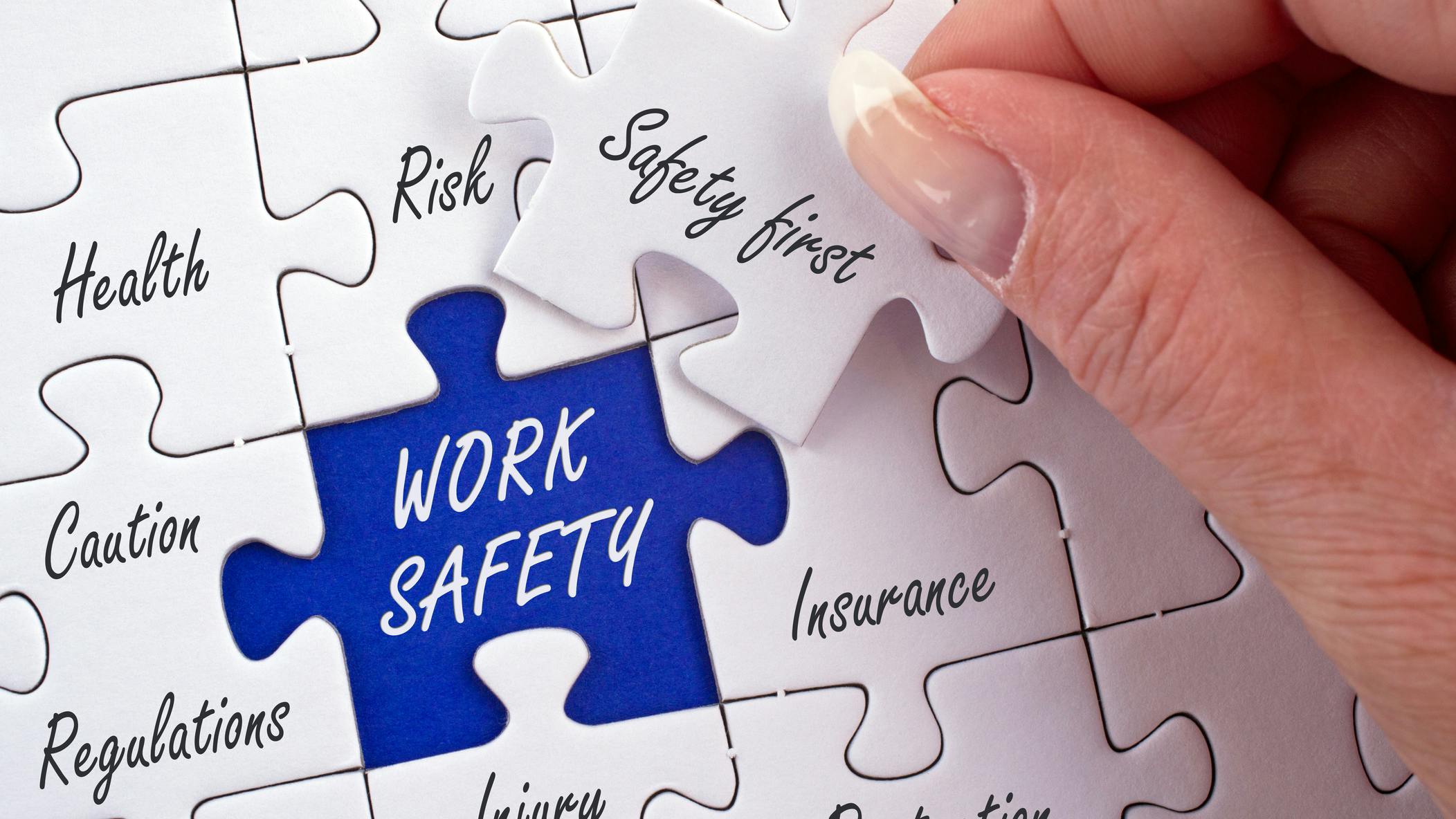 Work Safety Concept Puzzle with female hand and text