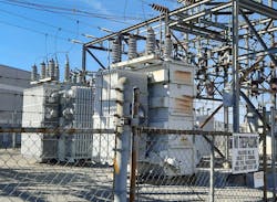 Photo 1. Oil-filled transformers equipped with insulator bushings (top), radiator fins, and cooling fans. Photo 1. Oil-filled transformers equipped with insulator bushings (top), radiator fins, and cooling fans.