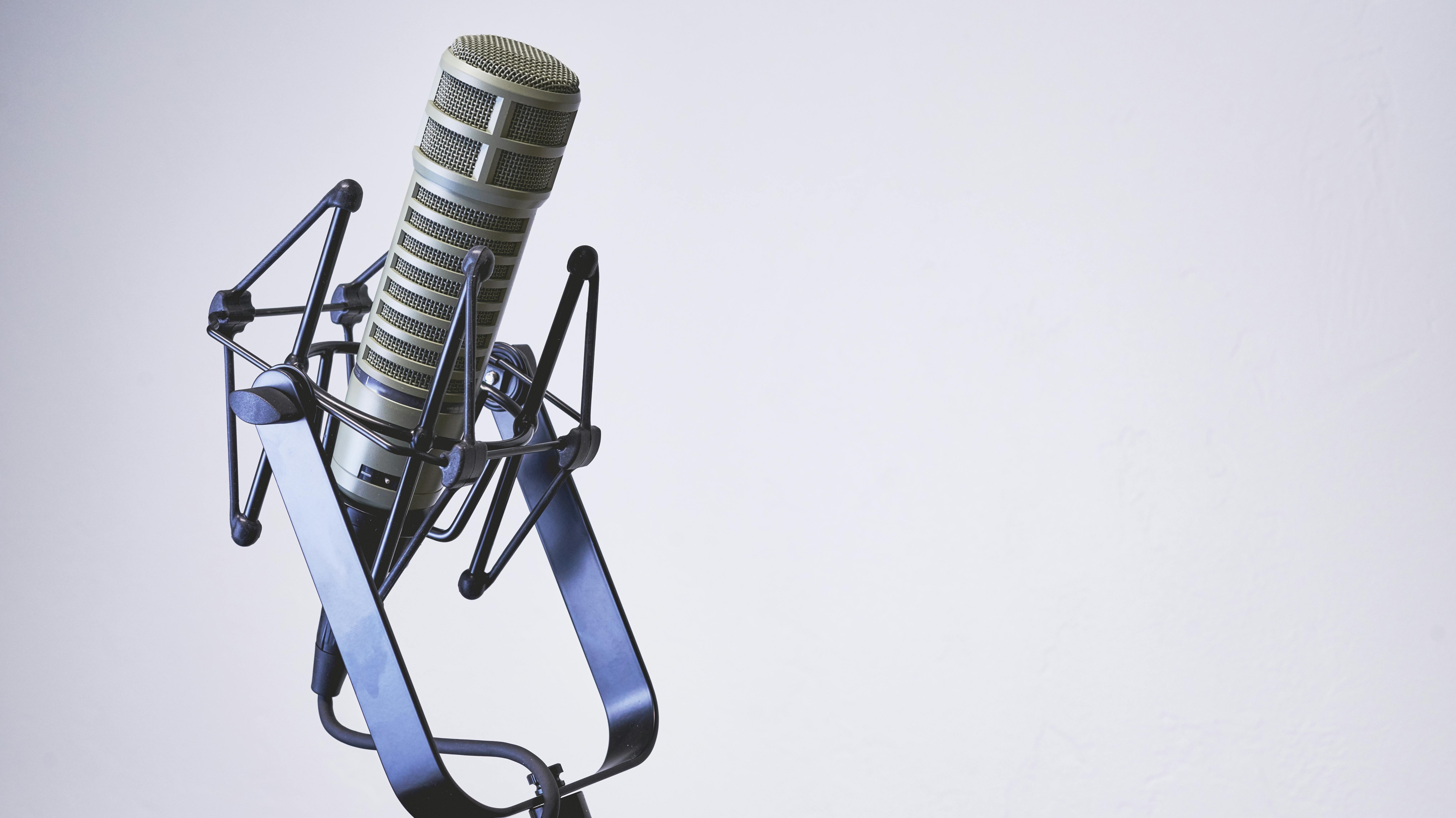 Podcast microphone isolated with a white background. Dynamic podcasting microphone hooked up and ready to record on a clean white background.