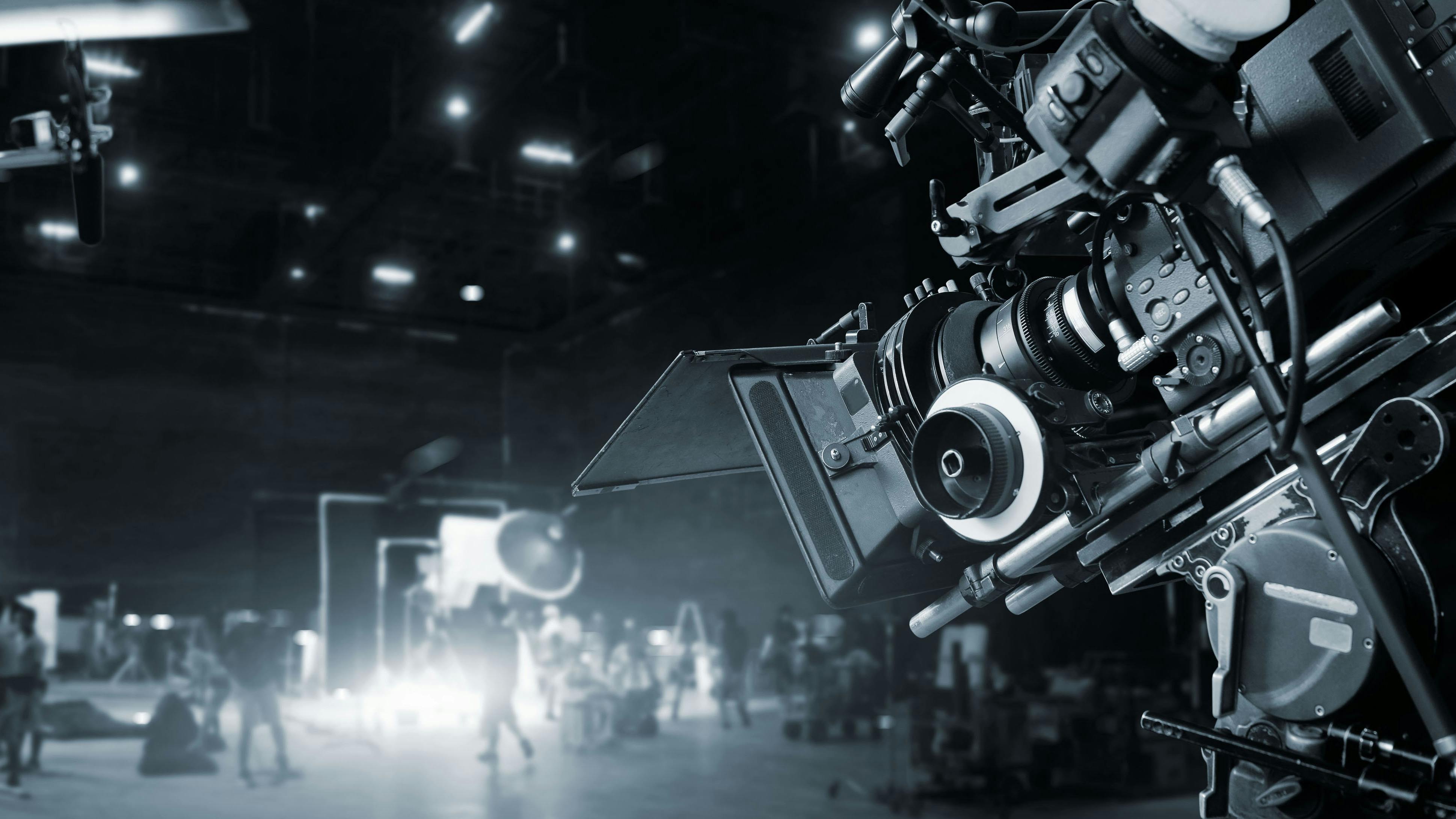 Behind the scenes of making of movie and TV commercial. Film Crew. B-roll. Camera of movie and video production and crew team in studio and set. Black and white.