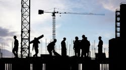 silhouette of construction workers working on scaffolding silhouette of construction workers working on scaffolding