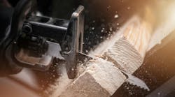 Reciprocating Saw Wood Work. Reciprocating Saw in Action Closeup Photo. Power Tool Wood Cutting Construction Theme. Reciprocating Saw Wood Work. Reciprocating Saw in Action Closeup Photo. Power Tool Wood Cutting Construction Theme.