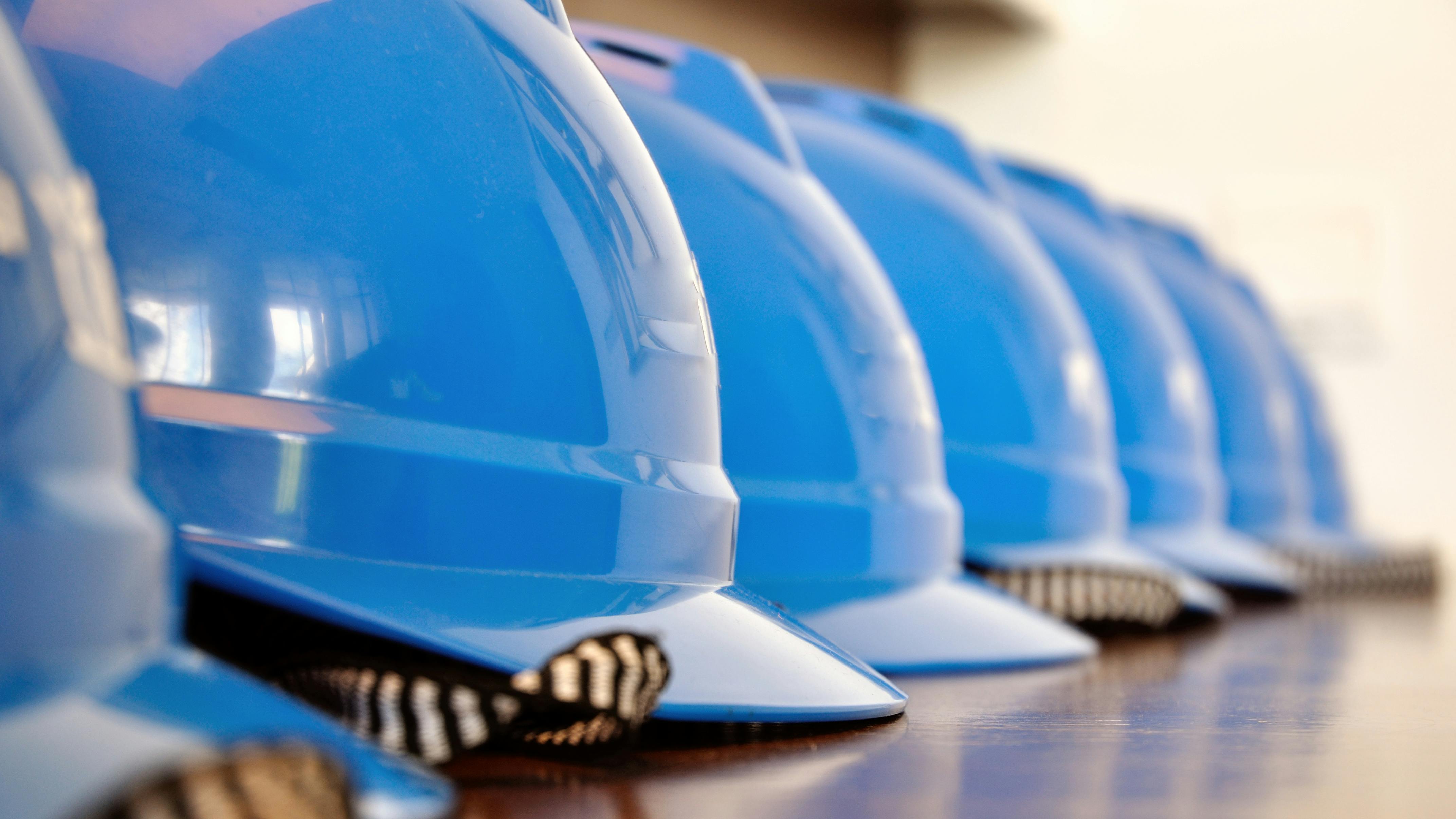 blue construction helmets in a row