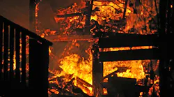 House on fire. Stairs and bedroom furniture silhouetted in house fire House on fire. Stairs and bedroom furniture silhouetted in house fire