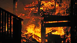 House on fire. Stairs and bedroom furniture silhouetted in house fire House on fire. Stairs and bedroom furniture silhouetted in house fire