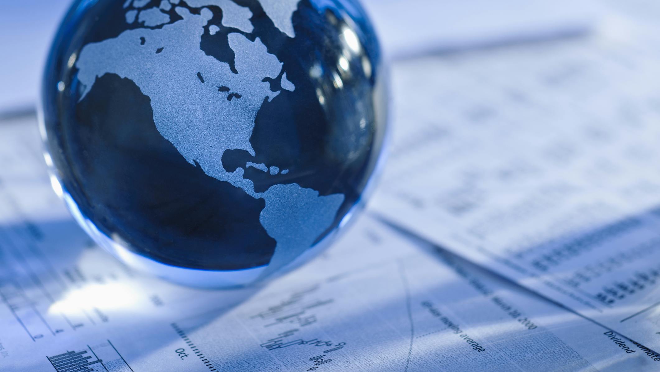 Globe with financial papers. Glass globe with North America and business papers