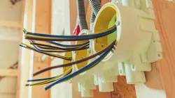 Electrical Wires and Installations in a Residential Construction Project. Electric wires are organized in junction boxes as part of home wiring during a construction project. This process ensures safety and efficiency in electrical systems Electrical Wires and Installations in a Residential Construction Project. Electric wires are organized in junction boxes as part of home wiring during a construction project. This process ensures safety and efficiency in electrical systems