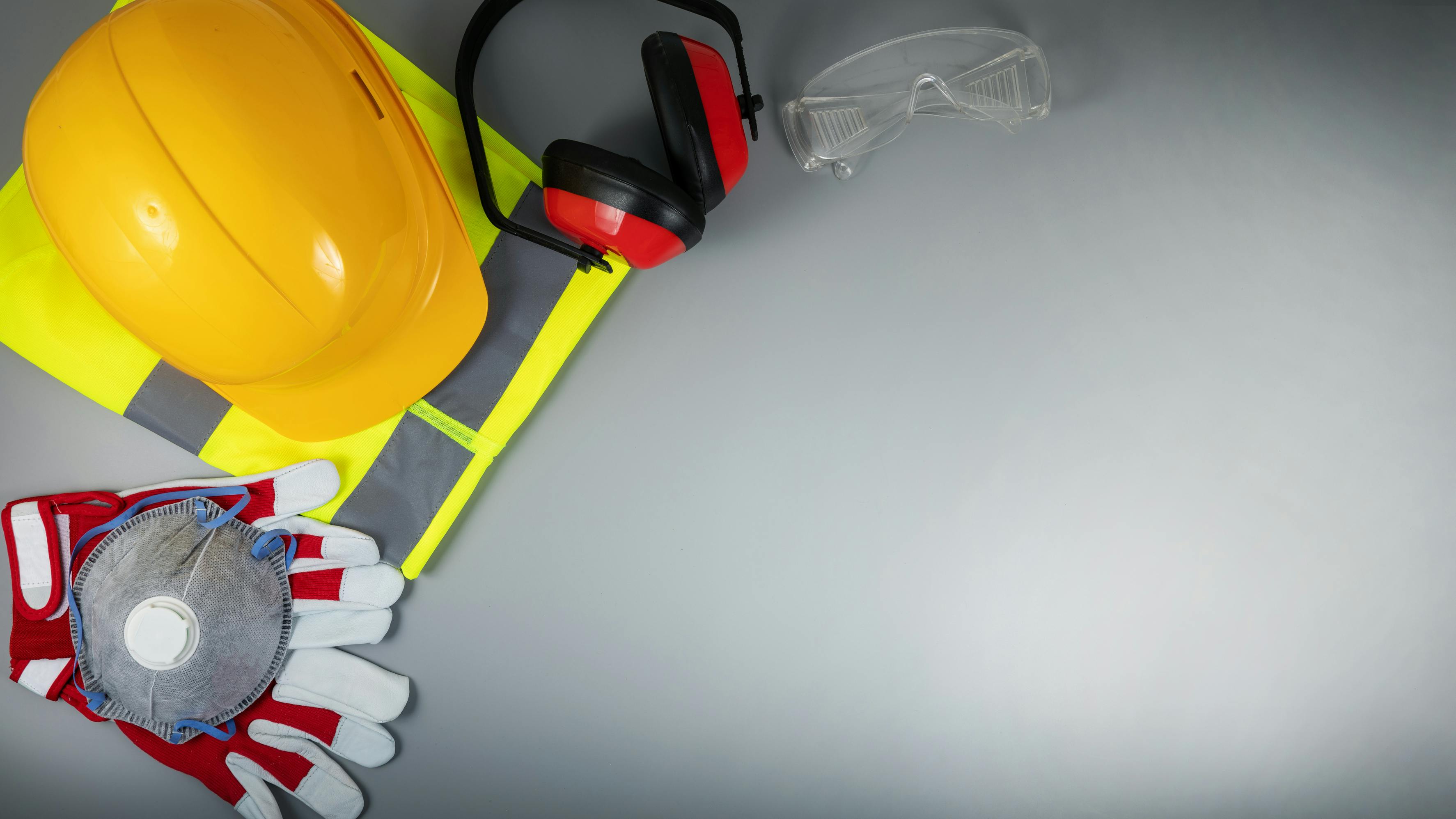 Occupational safety and health - work safety items of construction industry on gray background with copy space