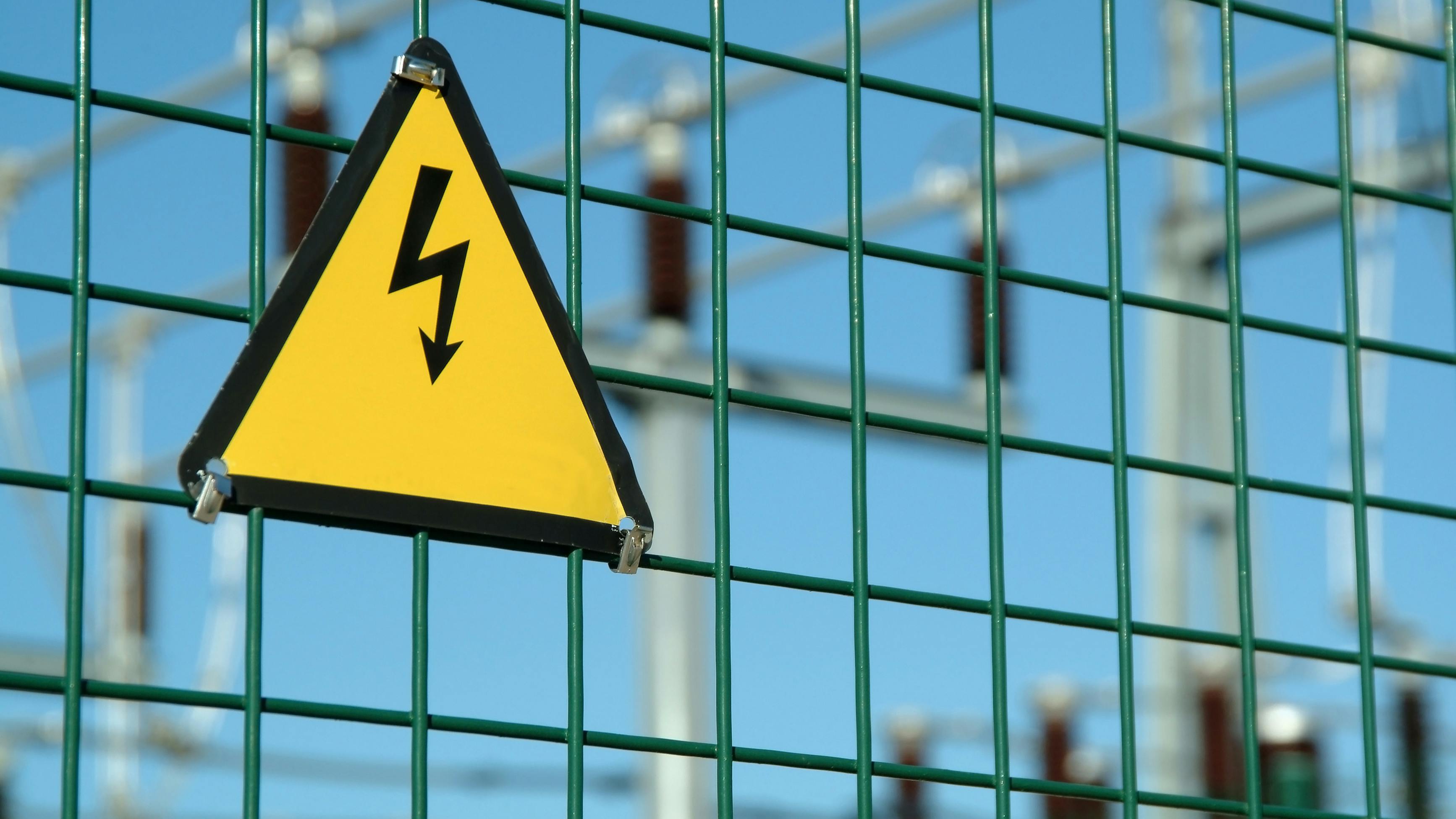 High voltage danger sign in fence of power plant