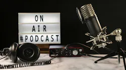 Podcast studio set with microphone, headphones, console and on air sign turned on,. Podcast studio set with microphone, headphones, console and “on air” sign turned on, over marble table and black background.