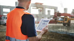 Foreman with ipad on job site