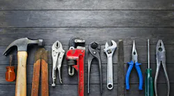 Tools Rustic Wood Background Business Construction. A still-life of tools on a rustic wood background.
