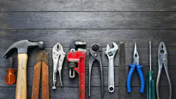 Tools Rustic Wood Background Business Construction. A still-life of tools on a rustic wood background.