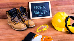 Safety first. Standard construction safety equipment on wood background