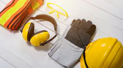 Standard construction safety equipment on wooden table. Standard construction safety equipment on white wooden background. safety first concepts